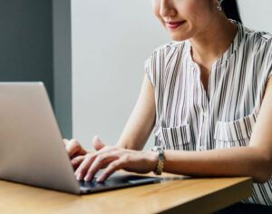 woman at desk typing