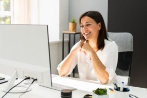 People-pleasing woman sitting at desk